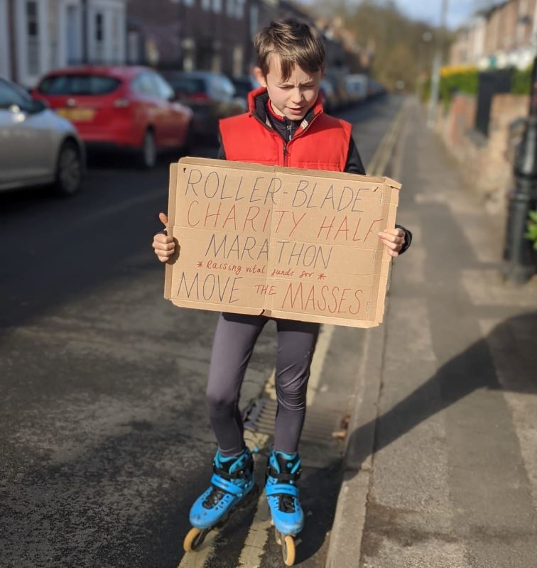 Noah on his skates with a fundraising sign