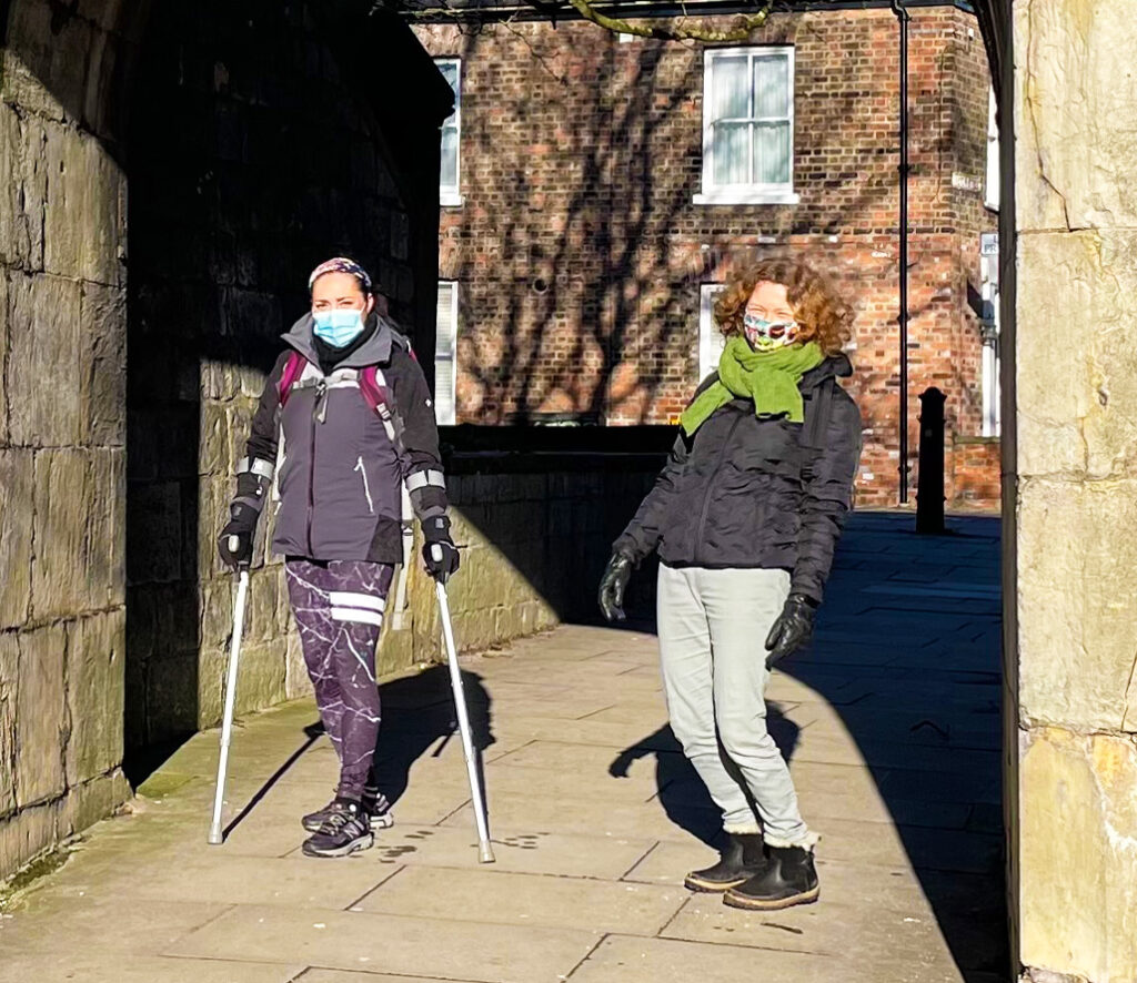 A volunteer and benefactor of a Move Mates project outside walking