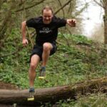 Matt jumping over a log