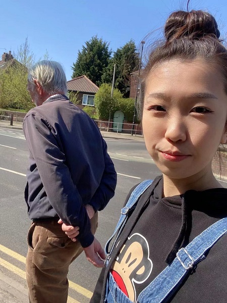 student volunteer and beneficiary walking